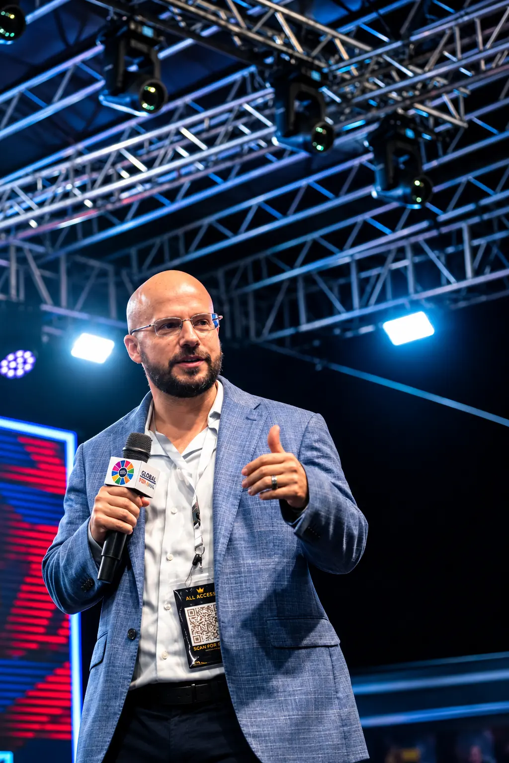 Calvin Smith speaking on stage with a microphone at a live business event