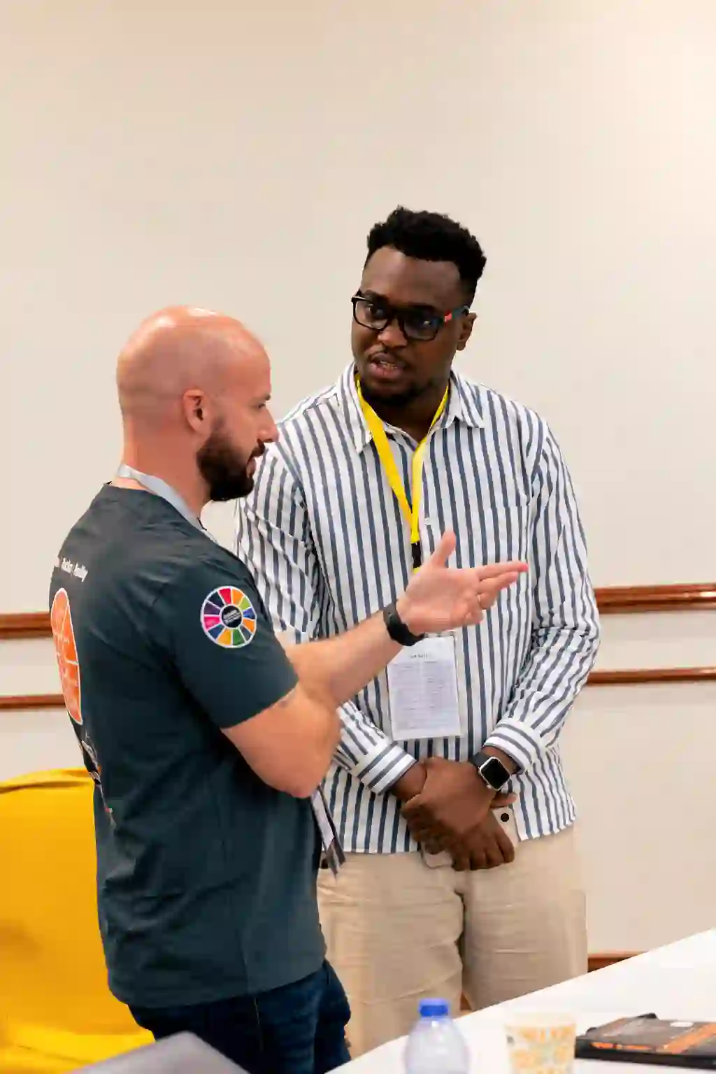 Calvin Smith talking with a conference attendee wearing a VIP guest badge