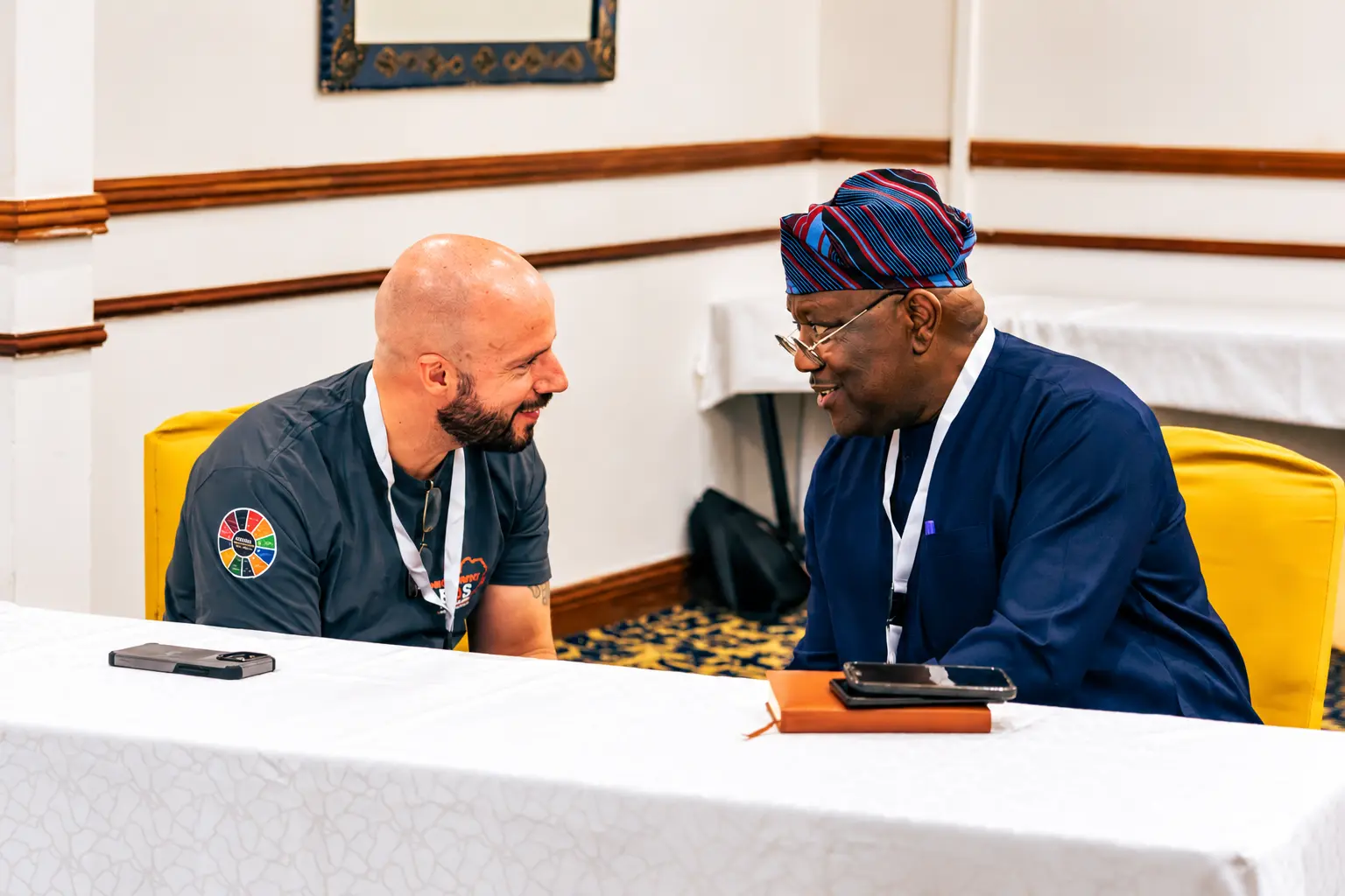 Calvin Smith in a one-on-one conversation with a business leader at a conference table